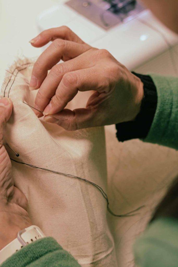 Leim Sewing workshops - jumpsuit sewing workshops - person pinning the sleeve cap of a jumpsuit into the bodice
