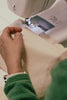 Leim Sewing workshops - jumpsuit sewing workshops - Person using a sewing machine with a close-up of their hand and green sleeve.